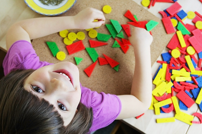 Best Maria Montessori quotes - a happy child in a Montessori classroom. 